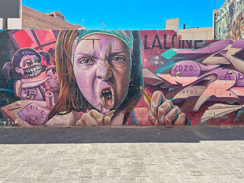 “Back To School” mural depicting an angry girl by Lalone in Málaga’s Lagunillas district