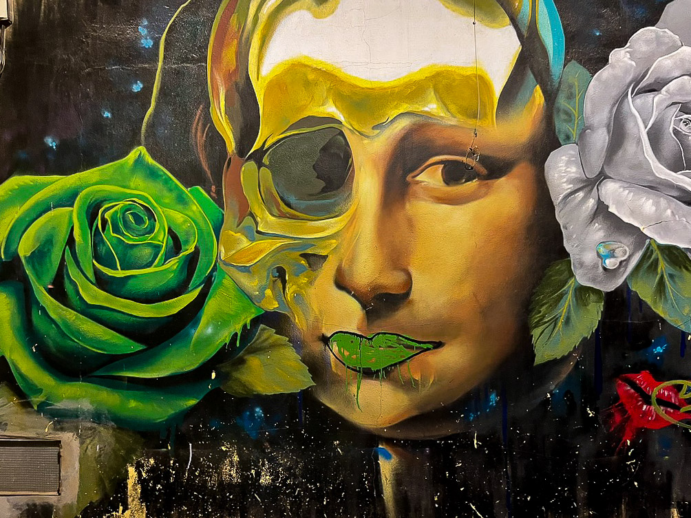 Mural from Doger of Mona Lisa with a green rose in Málaga’s Lagunillas district