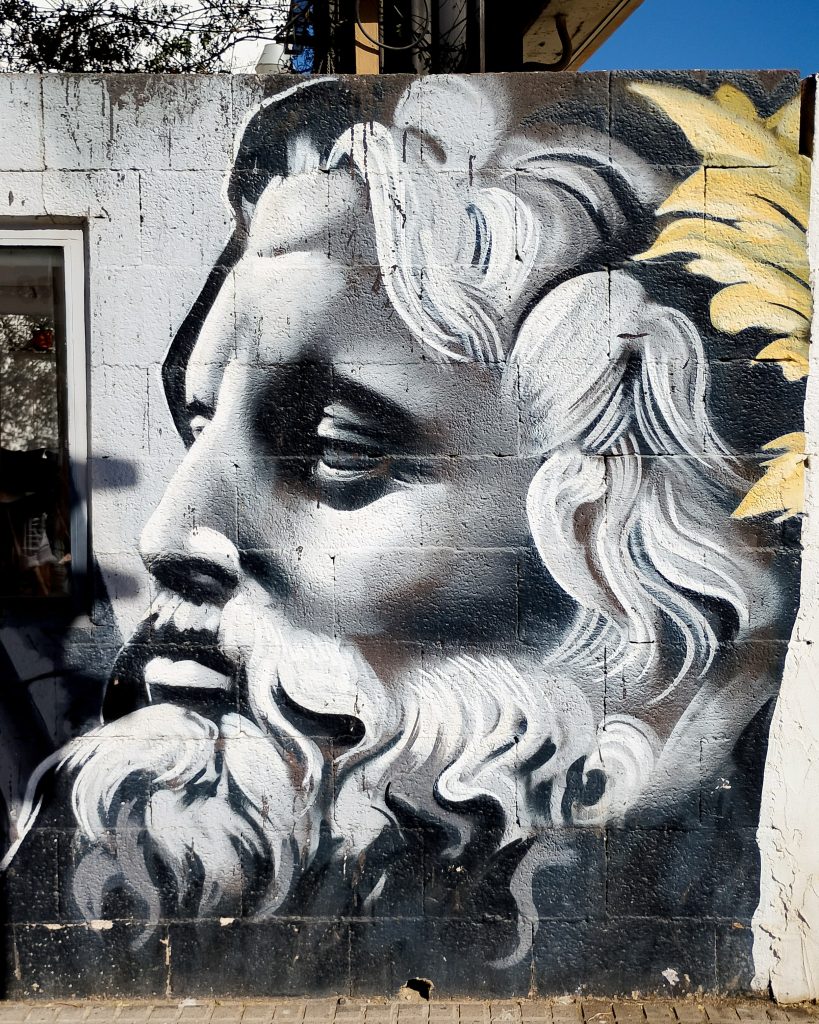 Greek-inspired mural by Lalone of a bearded classical male figure in Málaga