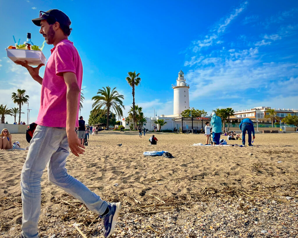 Málaga's Malagueta beach and La Farola lighthouse next to the port of Málaga and close to the old city centre