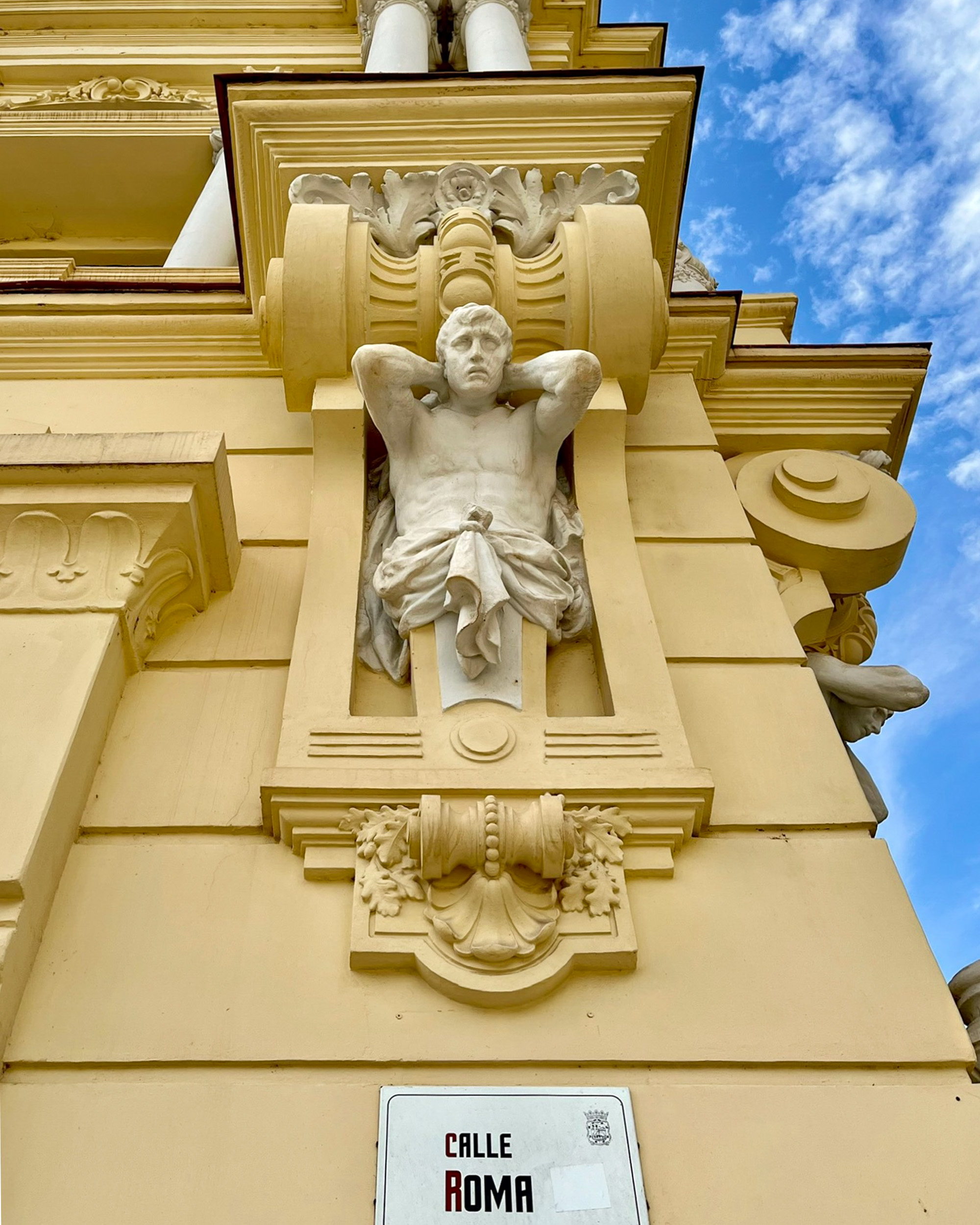 Málaga City Hall, featuring a Neo-Baroque style with distinctive Modernist details; a statue is visible from Calle Roma.