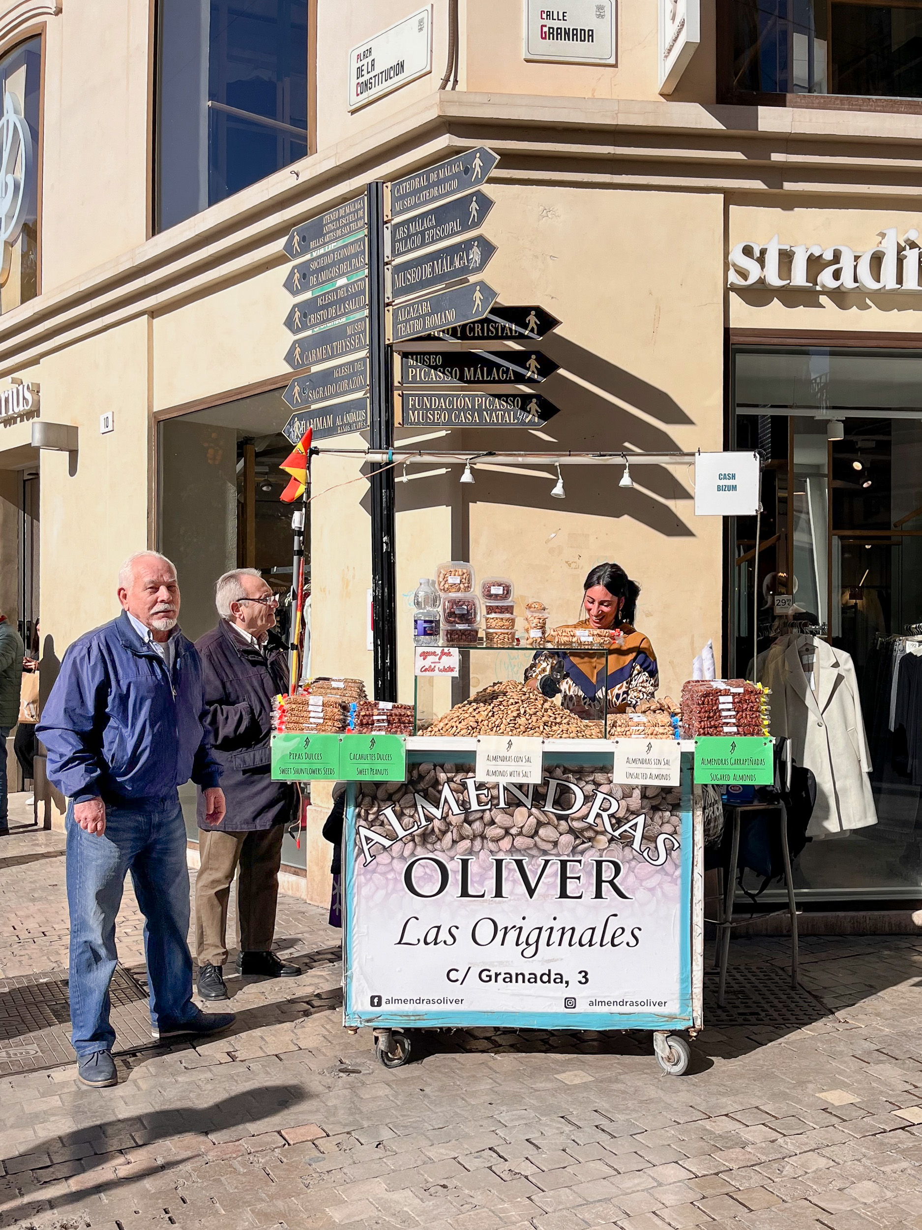 Oliver's almond stall at the corner of Granada Street and Plaza de la Constitución, selling almonds on the street in Málaga's historic city center