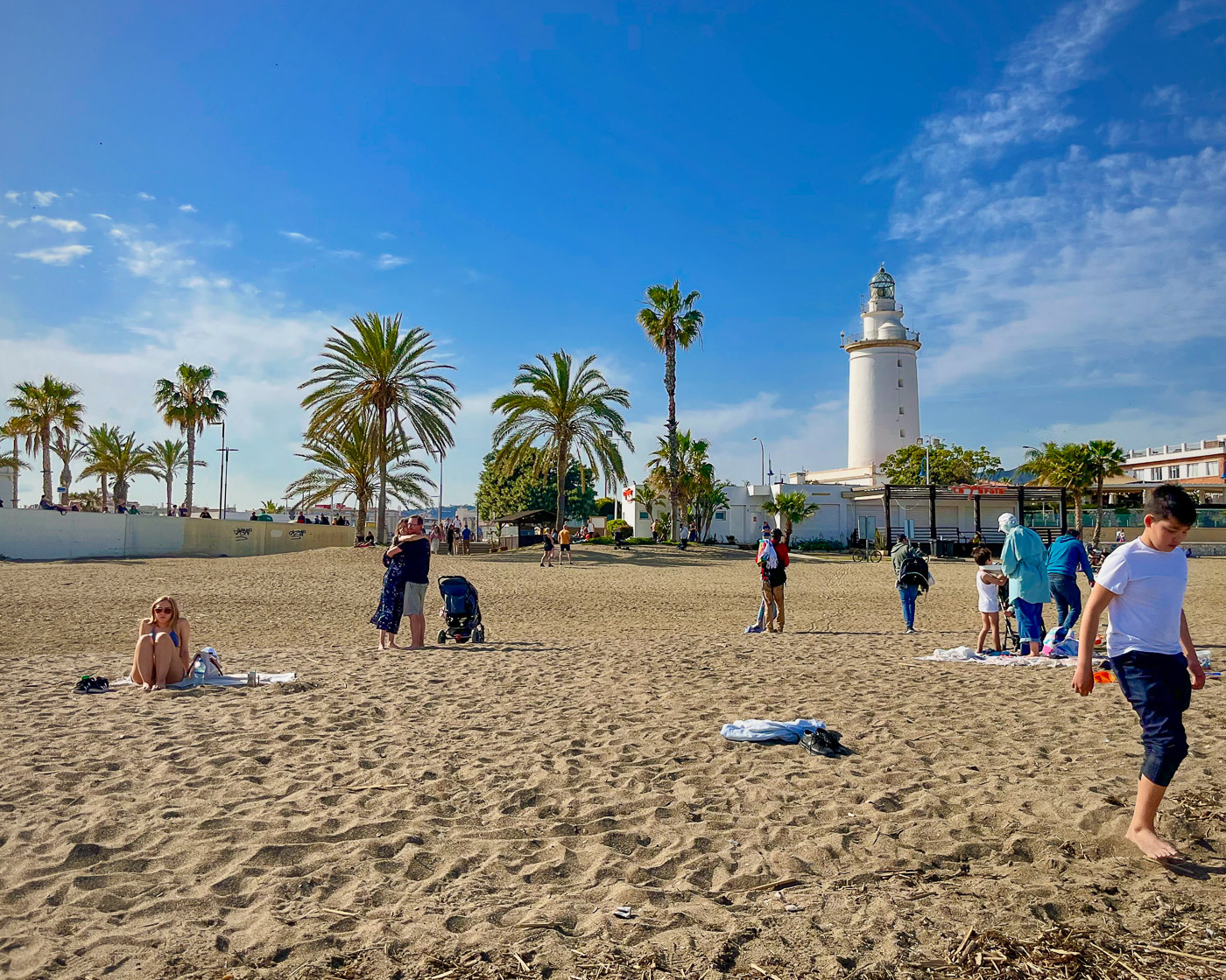 Málaga's La Malagueta beach and La Farola lighthouse next to the port of Málaga and close to the old city centre