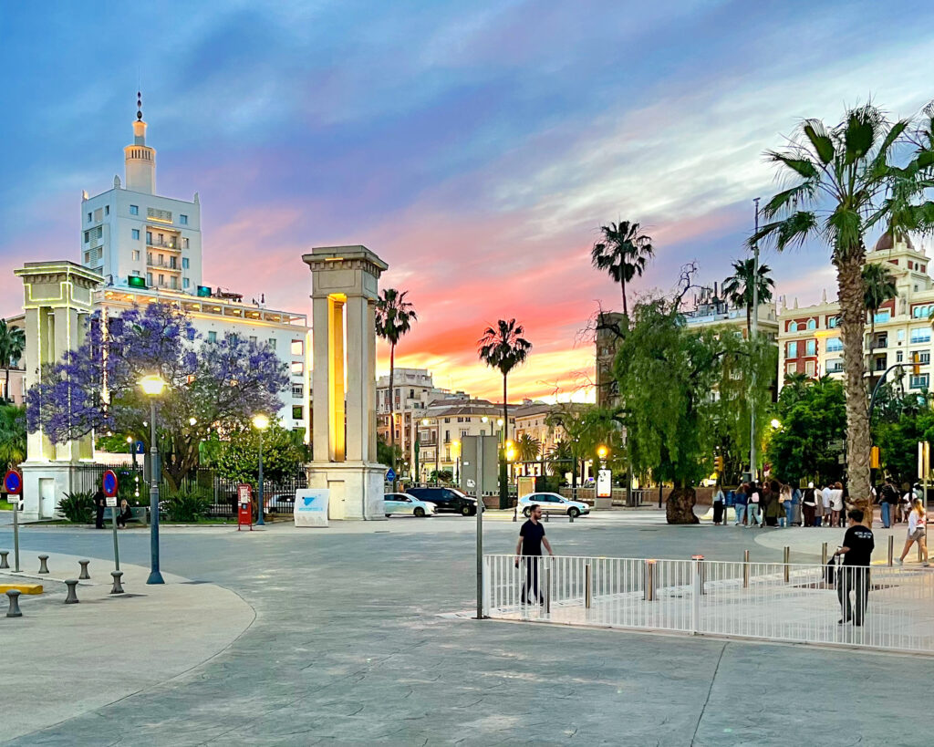 The La Equitativa building—which houses the Only You and Soho Boutique hotels—, Plaza de la Marina, and the columns, seen from Muelle Dos at the Port of Málaga at sunset